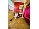 Cozy bathroom with a red accent wall, toilet, sink, and window with natural light at 1019 10Th W Ave, Bradenton, FL 34205