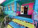Charming, vibrantly painted home with mosaic tiled steps and colorful railings leading to a welcoming entrance at 1019 10Th W Ave, Bradenton, FL 34205