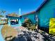 View of a vibrant turquoise home featuring a car port and colorful trim at 1019 10Th W Ave, Bradenton, FL 34205