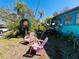 Whimsical cottage featuring colorful exterior and pink Adirondack chairs at 1019 10Th W Ave, Bradenton, FL 34205