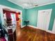 A green painted room with hardwood floors and doorway into another room at 1019 10Th W Ave, Bradenton, FL 34205