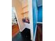 Hallway with built in shelving and decor with wood floors and blue accent wall at 1019 10Th W Ave, Bradenton, FL 34205