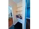 Hallway featuring built-in shelving with wood floors and a blue accent wall at 1019 10Th W Ave, Bradenton, FL 34205