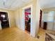 Bright hallway featuring wood floors, beadboard ceilings, and an open doorway at 1019 10Th W Ave, Bradenton, FL 34205