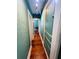 Interior hallway featuring green textured walls, built in drawers and hardwood floors at 1019 10Th W Ave, Bradenton, FL 34205