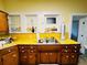 Functional kitchen showcasing yellow countertops and wood cabinets for ample storage at 1019 10Th W Ave, Bradenton, FL 34205