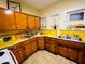 Bright kitchen featuring yellow countertops, wood cabinets, and ample natural light at 1019 10Th W Ave, Bradenton, FL 34205