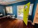 Bright living room featuring hardwood floors, an open doorway, and cheerful blue walls at 1019 10Th W Ave, Bradenton, FL 34205
