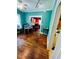 Open living room with hardwood floors, vibrant accent wall, and archway to dining area at 1019 10Th W Ave, Bradenton, FL 34205