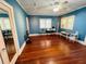 Large blue room with wooden floors, bright windows, and plenty of light at 1019 10Th W Ave, Bradenton, FL 34205