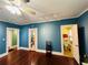 Large blue room with hardwood floors and doorways to other rooms at 1019 10Th W Ave, Bradenton, FL 34205