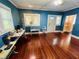 Large blue room with hardwood floors and bright windows at 1019 10Th W Ave, Bradenton, FL 34205