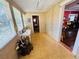 Bright sunroom with multiple windows and light wood-look floors, transitioning to an adjacent room at 1019 10Th W Ave, Bradenton, FL 34205