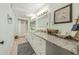 Bright bathroom featuring a dual sink vanity with granite counters and a shower at 102 28Th W St, Bradenton, FL 34205