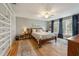 Comfortable bedroom with hardwood floors, ceiling fan, and large windows at 102 28Th W St, Bradenton, FL 34205