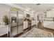 Modern kitchen with stainless steel refrigerator and range, granite countertops, and ample cabinet space at 102 28Th W St, Bradenton, FL 34205