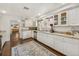 Bright kitchen with white cabinets, granite countertops, stainless steel appliances, and hardwood floors at 102 28Th W St, Bradenton, FL 34205