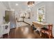 Charming kitchen with a stainless steel refrigerator, white cabinetry, and a cozy breakfast nook at 102 28Th W St, Bradenton, FL 34205