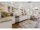 Bright kitchen with white cabinets, granite countertops, stainless steel appliances, and hardwood floors at 102 28Th W St, Bradenton, FL 34205