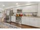 Well-equipped kitchen featuring stainless steel appliances, white cabinetry, and granite countertops at 102 28Th W St, Bradenton, FL 34205