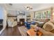 Cozy living room featuring a fireplace, neutral-toned furniture, and a large window with a view at 102 28Th W St, Bradenton, FL 34205
