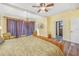 Elegant main bedroom with chandelier, TV, and walk-in closet at 102 28Th W St, Bradenton, FL 34205