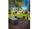 Serene backyard with comfortable outdoor seating area, brick patio, and lush green lawn at 10315 Cortez W Rd # 32-7, Bradenton, FL 34210