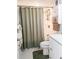 Bathroom featuring a toilet, shower with curtain, white cabinet and shelving for storing essentials at 10315 Cortez W Rd # 32-7, Bradenton, FL 34210