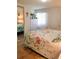 Comfortable bedroom with bright, floral bedding, light wood flooring, and a closet with mirrored doors at 10315 Cortez W Rd # 32-7, Bradenton, FL 34210