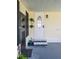 Charming front entrance with decorative door, steps, and adjacent screen door and pleasant outdoor features at 10315 Cortez W Rd # 32-7, Bradenton, FL 34210