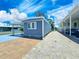 Charming blue mobile home with well-maintained exterior and a convenient carport at 10315 Cortez W Rd # 32-7, Bradenton, FL 34210