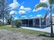 Charming mobile home with a spacious porch and well-maintained lawn at 10315 Cortez W Rd # 32-7, Bradenton, FL 34210