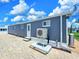 Exterior side view of a home with a paved driveway and an air conditioning unit at 10315 Cortez W Rd # 32-7, Bradenton, FL 34210