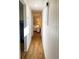 Bright hallway with wood floors leading to a cozy bedroom and a full bath at 10315 Cortez W Rd # 32-7, Bradenton, FL 34210