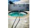 Relaxing hot tub surrounded by a patio and white privacy fence, with safety features in view at 10315 Cortez W Rd # 32-7, Bradenton, FL 34210