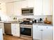Modern kitchen featuring stainless steel appliances, white cabinets, and stylish countertops at 10315 Cortez W Rd # 32-7, Bradenton, FL 34210