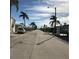 Street view showcasing palm trees and well-maintained mobile homes in a desirable neighborhood at 10315 Cortez W Rd # 32-7, Bradenton, FL 34210