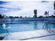 Community pool on a sunny day, with lounge chairs and safety features at 10315 Cortez W Rd # 32-7, Bradenton, FL 34210