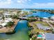 An aerial view of a neighborhood shows waterfront homes, canals, and access to the ocean at 104 Pops Ln, Nokomis, FL 34275
