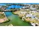 Aerial view of waterfront homes with private docks and canal access to the bay at 104 Pops Ln, Nokomis, FL 34275