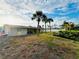 This property features a beautiful backyard with palm trees, leading to a waterfront view at 104 Pops Ln, Nokomis, FL 34275