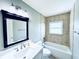 Bright bathroom features a tub/shower combo and new white cabinets at 104 Pops Ln, Nokomis, FL 34275
