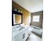 Bathroom boasts granite vanity and a shower-tub combination at 104 Pops Ln, Nokomis, FL 34275