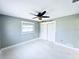 Light-filled bedroom featuring a ceiling fan, window, and closet with a fresh coat of neutral paint at 104 Pops Ln, Nokomis, FL 34275