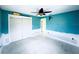 Bedroom with blue walls, a ceiling fan, a closet with white doors, and white trim at 104 Pops Ln, Nokomis, FL 34275
