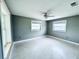 Bright bedroom with new carpet, neutral paint, and large windows at 104 Pops Ln, Nokomis, FL 34275