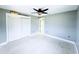 Large bedroom featuring a ceiling fan, neutral paint, white trim, and closet at 104 Pops Ln, Nokomis, FL 34275