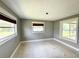 Well-lit bedroom with windows and neutral paint, awaiting personal touch at 104 Pops Ln, Nokomis, FL 34275