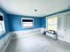 Bright bedroom featuring blue walls, and natural light from two windows at 104 Pops Ln, Nokomis, FL 34275