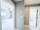 Hallway view showcasing access to a bedroom and bathroom and neutral paint and trim throughout at 104 Pops Ln, Nokomis, FL 34275